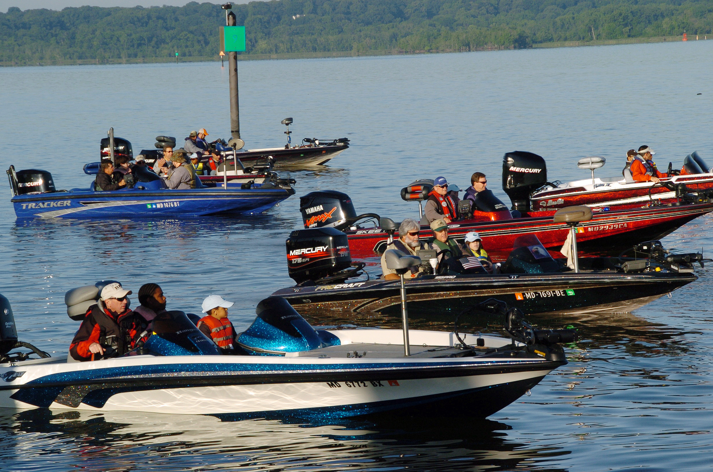 The participants of the 2009 Nation's River Bass Tournament head out on the Potomac River in speedboats.